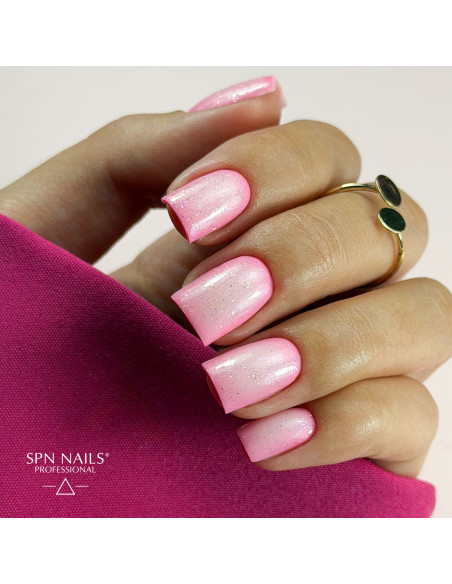 Neonowy różowy manicure z wykończeniem topem hybrydowym Glow Top Gloss Boss 10 ml i opalizującymi drobinkami